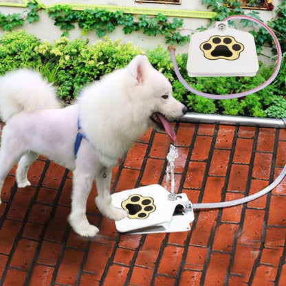 white dog uses white colored dog water fountain with a black colored and yellow framed paw printed on it